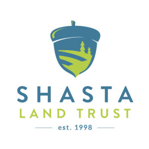 Acorn log with words "Shasta Land Trust" underneath logo. Est. 1998.